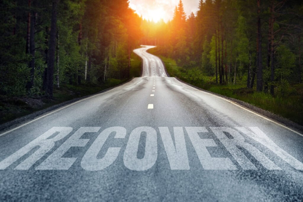 Country road and Recovery written on the road