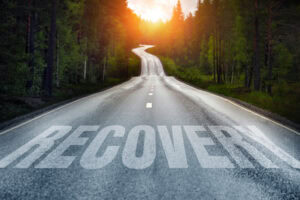 Country road and Recovery written on the road